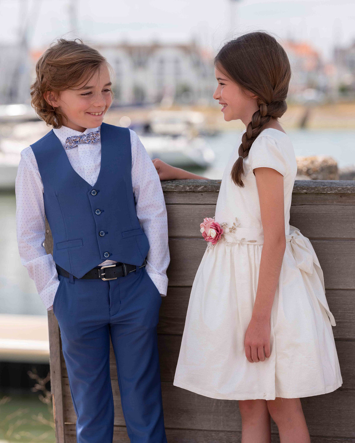 Costume bleu et robe blanche avec des détails de fleurs roses