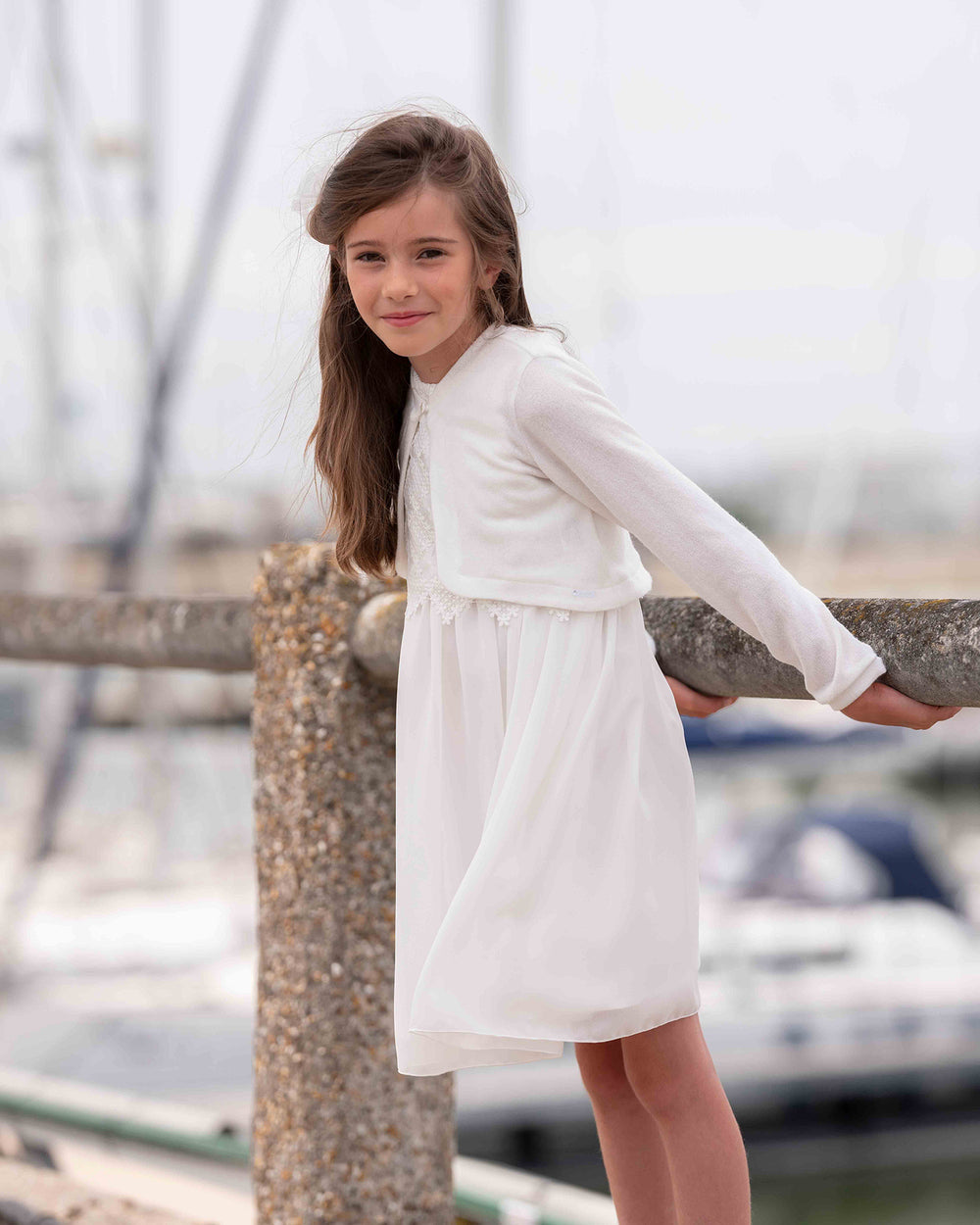 Supple white dress with detailed top and white cardigan